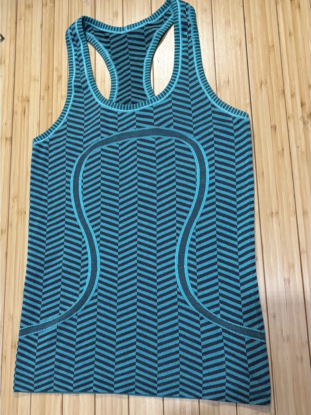 Lululemon swiftly hip length tank. Size 4. Teal and black. Very good condition.